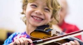 smiling-child-playing-violin